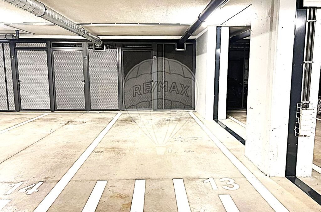 Spacious underground garage area with clean white lines and designated parking bays.