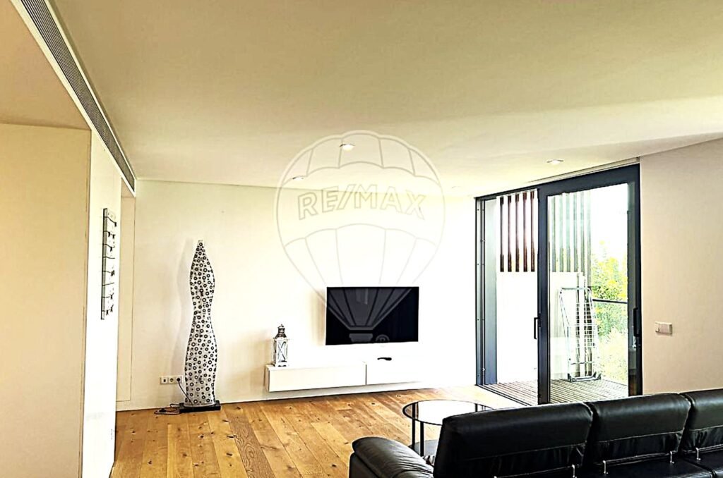 Comfortable lounge setup featuring a wall-mounted TV and minimalist décor.