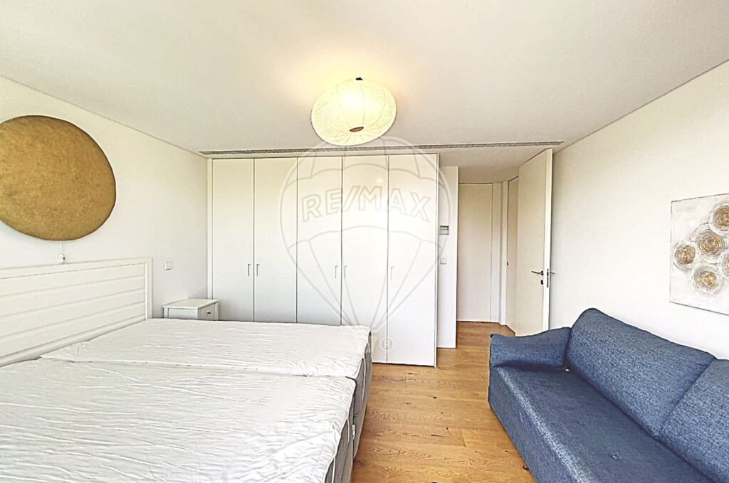 Bedroom view highlighting the built-in, floor-to-ceiling wardrobes for maximum storage.