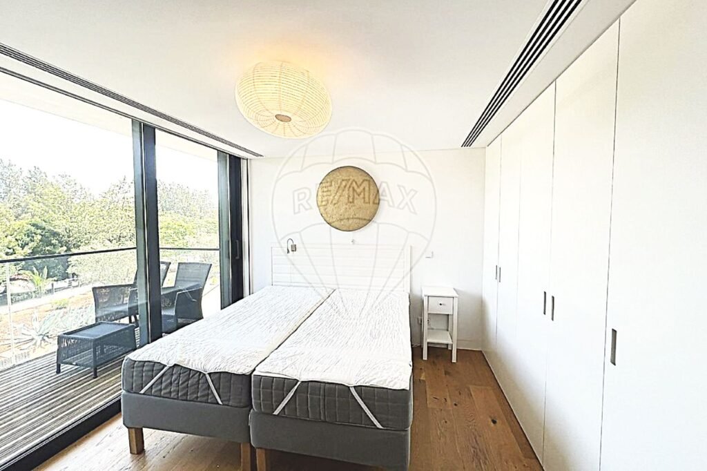 Bright bedroom with a large side door providing direct access to a private veranda.