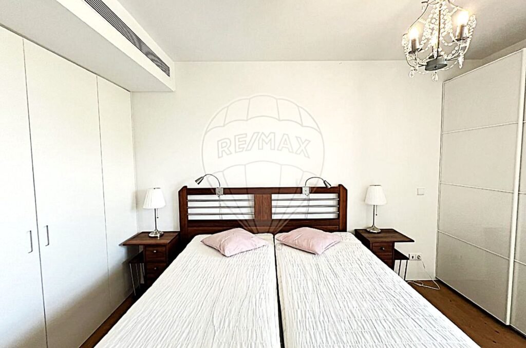 Frontal view of a master bedroom designed with a soft, neutral color palette.