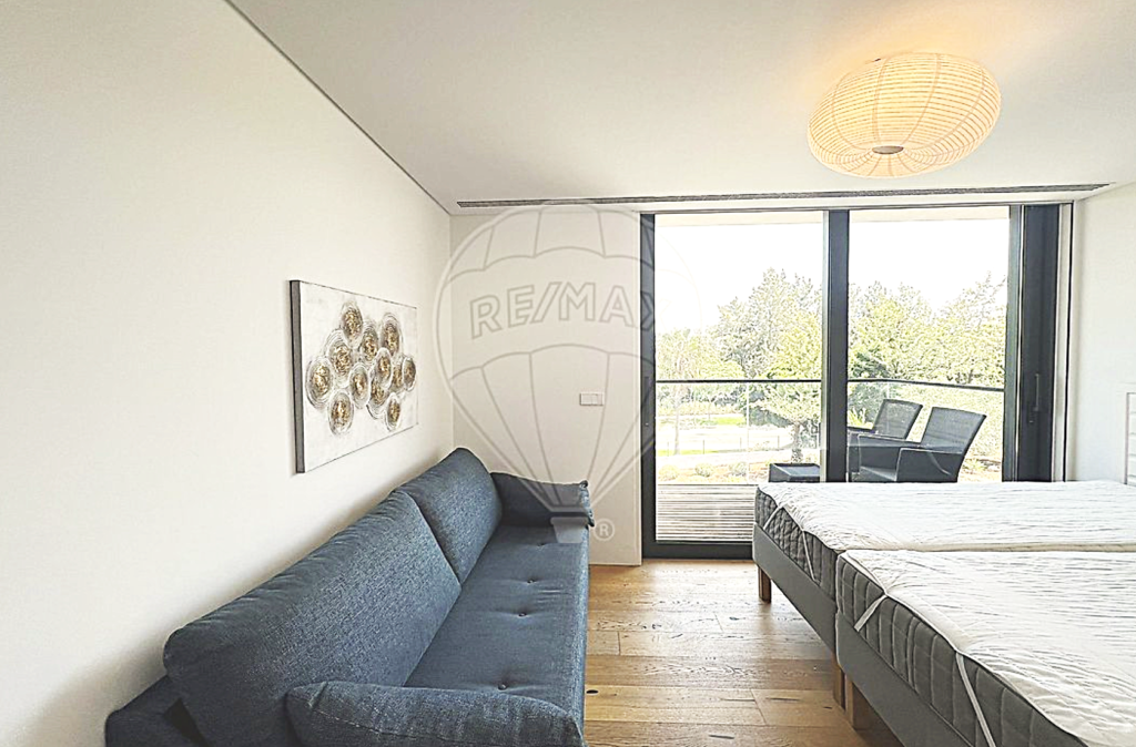 Large bedroom featuring an integrated seating area with a stylish couch.