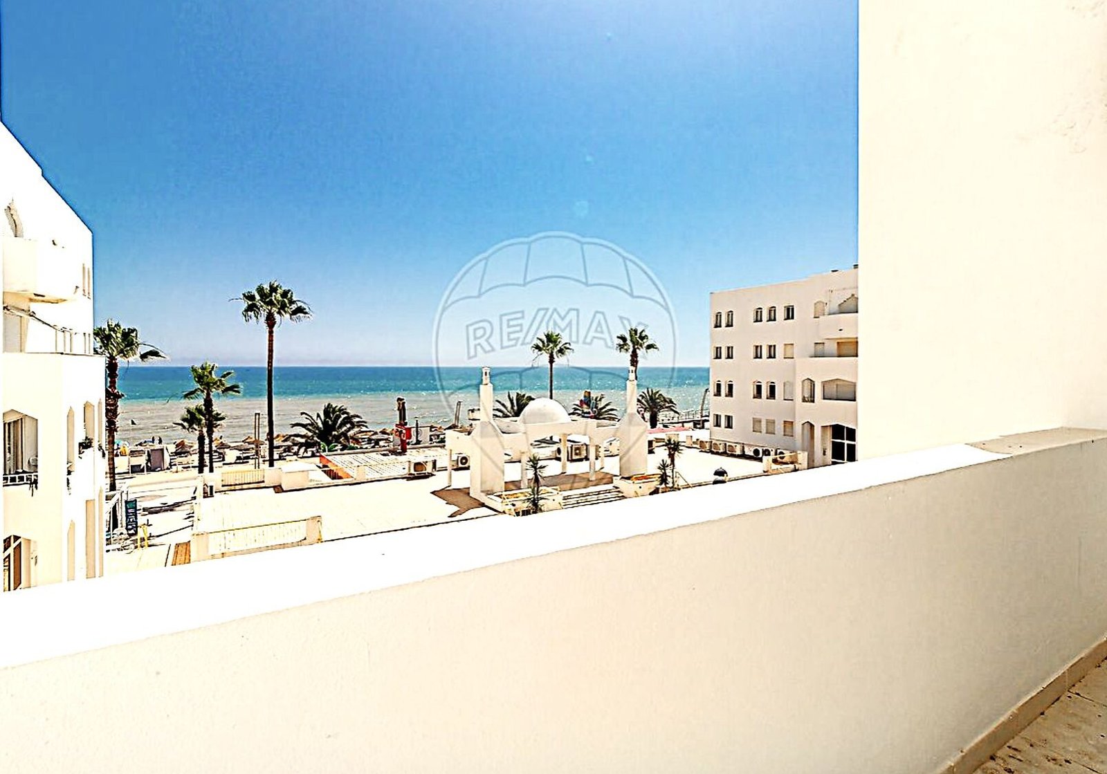 Sea view from the balcony of a renovated frontline T2 apartment at Edifício Atlântida, Quarteira, Algarve, with open-plan layout and private garage