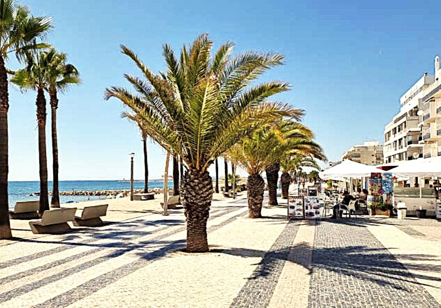 Seaside promenade with cafes near Quarteira real estate Portugal