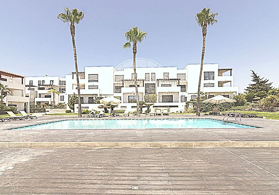 Front view of the condominium swimming pool with Vilamoura apartments in the background and landscaped gardens
